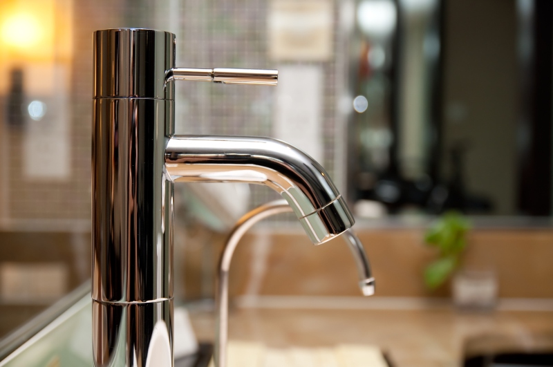 Leaking tap being repaired in Enfield